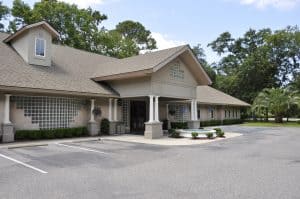 Modern Rochester property management office building with accessible parking and lush landscaping, specializing in residential and commercial property management services.