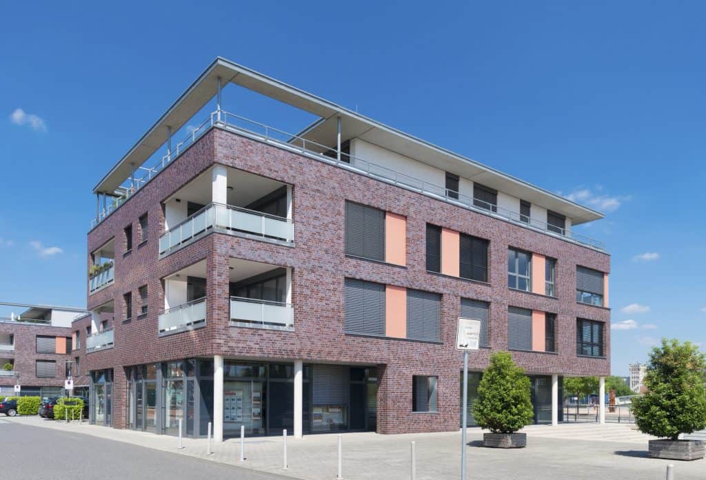Modern multi-story residential building with brick façade and spacious balconies, located in Rochester, NY. Ideal for property management, apartments, and rental services.