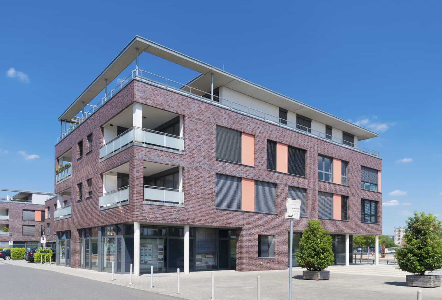 Modern multi-story residential building with brick façade and spacious. Ideal for property management, apartments, and rental services.