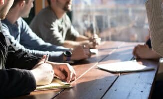 High-level business meeting at Rochester Property Management Group discussing real estate strategies and property management solutions in Rochester.