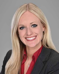 High-quality professional portrait of a smiling woman in business attire, representing Rochester Property Management Group, showcasing expert property management services in Rochester, NY.