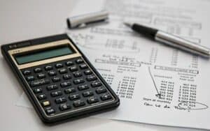 Calculator and financial documents on a desk, representing property management and financial planning services.