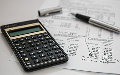 Calculator and financial documents on a desk, representing property management and financial planning services.