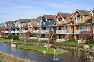 Colorful multi-story apartment complex with a water feature and manicured landscaping in Rochester.